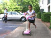 Bhutanese girl on scooter in front of home