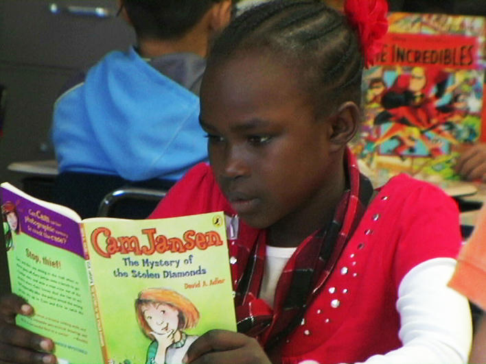 Darfuri girl reading at school
