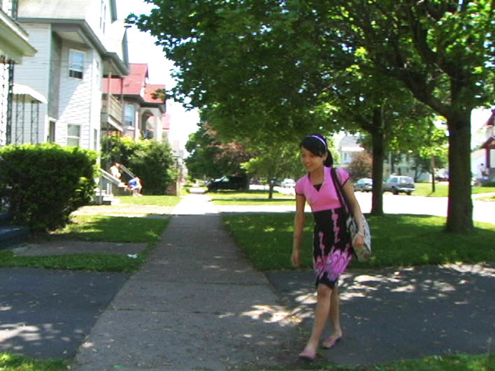 Girl from Burma walking home from school bus