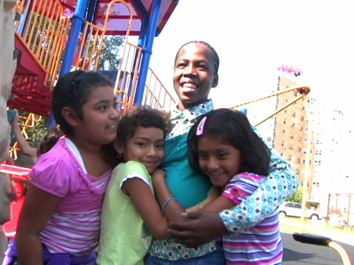 Girls on a playground hugging
